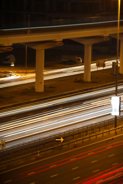 a city street filled with lots of traffic at night, a picture, inspired by Andreas Gursky, flickr, overpass, shafts of light, dramatic lighting - n 9, jeddah city street