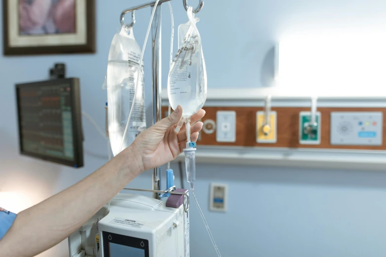 a close up of a person in a hospital room, pouring, two hang, healing tubes, professional photo