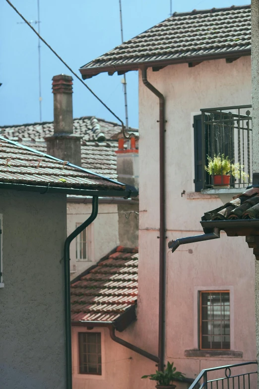 a couple of buildings that are next to each other, an album cover, inspired by Jacopo Bassano, pexels contest winner, renaissance, view from window, bright summer day, drainpipes, detailed color scan