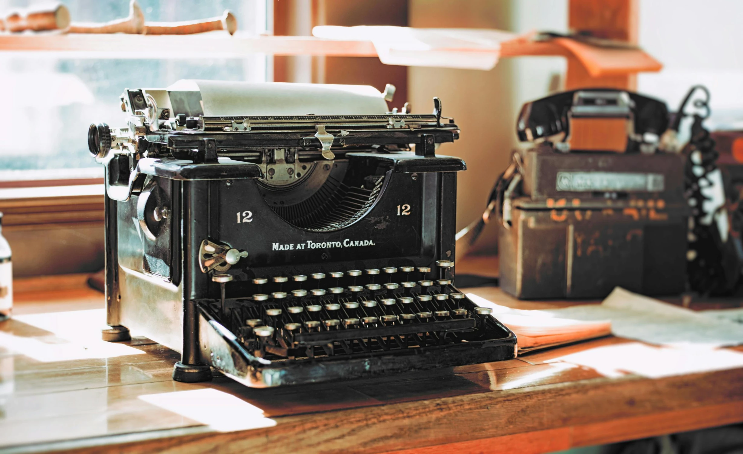 an old typewriter sitting on top of a wooden table, by Carey Morris, pexels contest winner, private press, vintage - w 1 0 2 4, home office, thumbnail, multiple stories