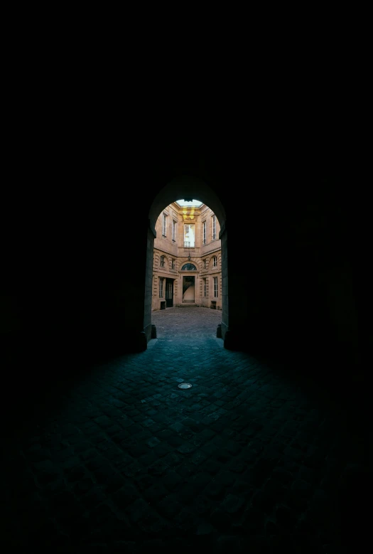 a dark tunnel with a light at the end, unsplash contest winner, romanesque, a wide open courtyard in an epic, iso 1 0 0 wide view, keyhole, taken at golden hour