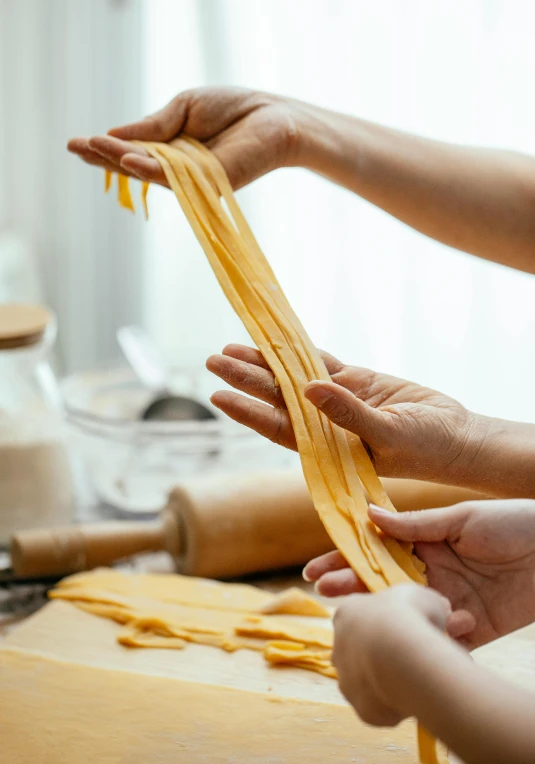 a couple of people that are making some kind of pasta, inspired by Li Di, trending on pexels, square, hands, banner, long