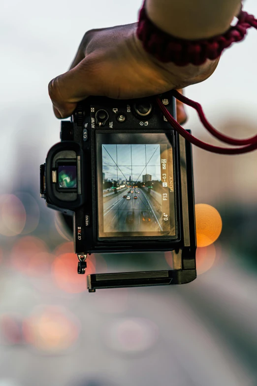 a close up of a person holding a camera, a picture, looking through a window frame, 2019 trending photo, car shot, glossy photo