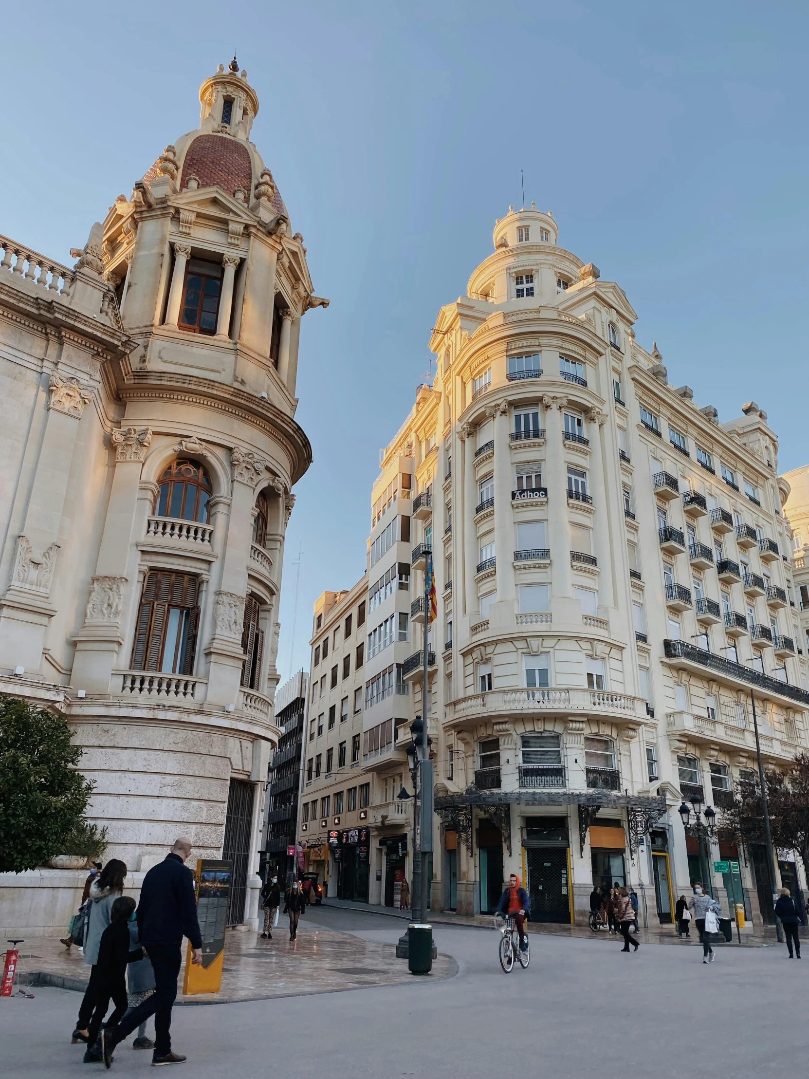 a group of people walking down a street next to tall buildings, art nouveau, seville, profile image