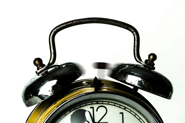 a black and gold alarm clock on a white background, an album cover, by Matija Jama, pixabay, happening, extreme close shot, illusion of bent time, aged 2 5, high-contrast