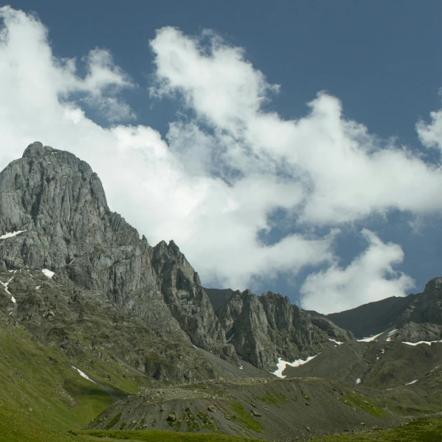 a herd of cattle grazing on top of a lush green hillside, by Werner Andermatt, pexels contest winner, les nabis, tall stone spires, with a snowy mountain and ice, minimalist, geological strata