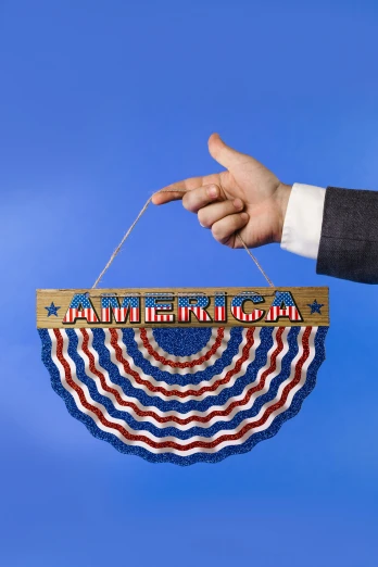 a person holding an american flag hanging from a string, inspired by Americo Makk, sign, slide show, very ornate, full product shot