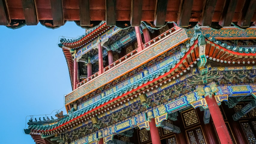 a colorful building with a blue sky in the background, inspired by An Zhengwen, pexels contest winner, cloisonnism, pillars on ceiling, castles and temple details, beijing, there are archways