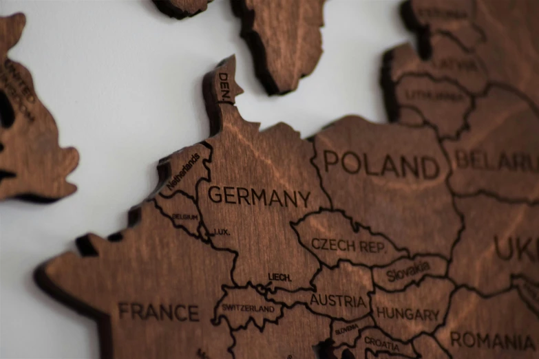 a close up of a map on a wall, walnut wood, detailed product shot, map of europe, dezeen
