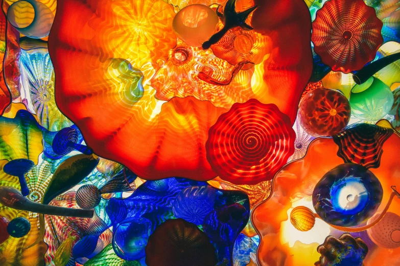 a bunch of colorful glass flowers hanging from a ceiling, trending on unsplash, abstract expressionism, mushroom city, red and orange glow, 🦩🪐🐞👩🏻🦳, colorful mosaic