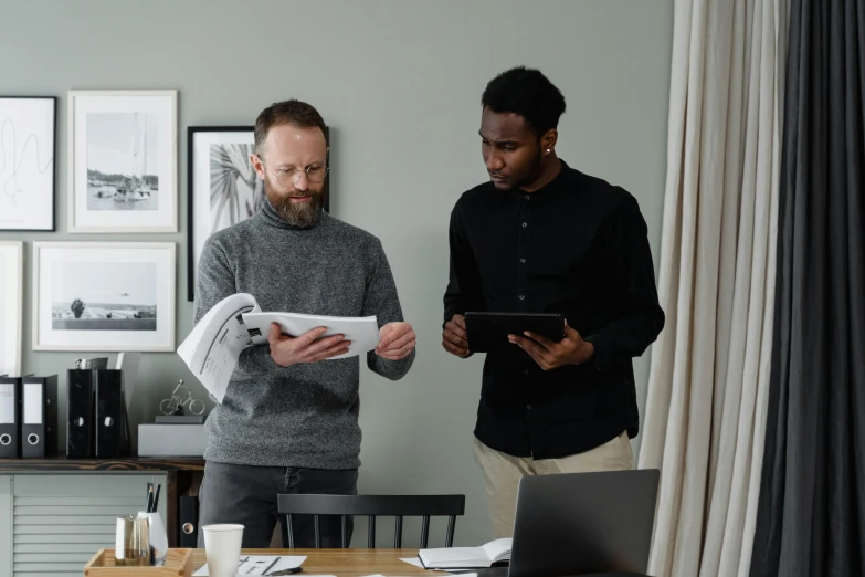 a couple of men standing next to each other in a room, pexels contest winner, character sheets on table, working in an office, high quality paper, avatar image