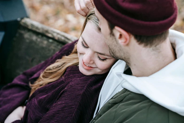 a man and a woman sitting next to each other, trending on pexels, wearing a purple breton cap, red woods canopy love, close up image, cuddling