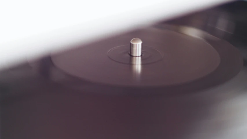 a close up of a record on a turntable, by Ottó Baditz, unsplash, smooth surface render, purple, dieter rams, brown