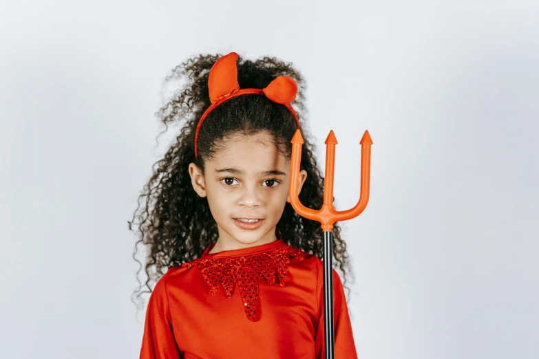 a little girl dressed up as a devil with a pitchfork, pexels, madeline from celeste, high resolution product photo, frontal picture, diverse costumes