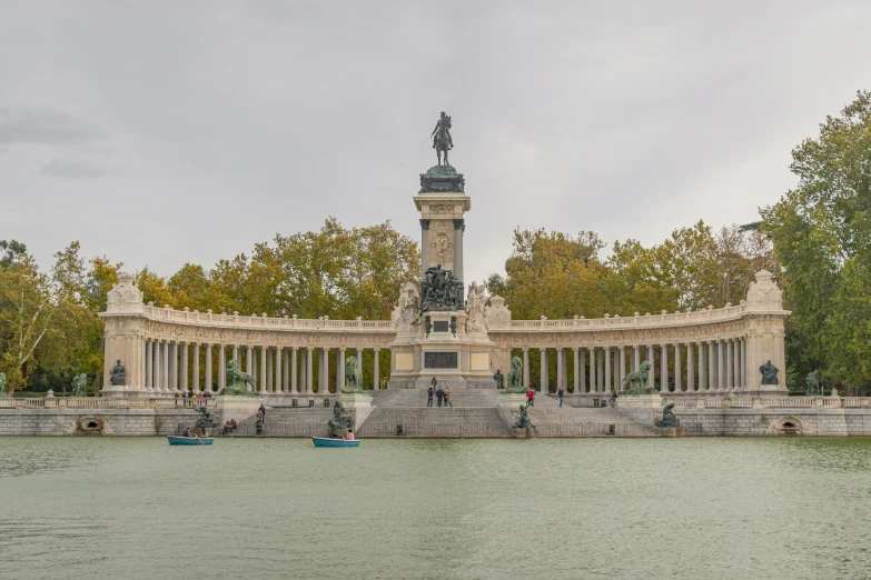 a monument in the middle of a body of water, a statue, panoramic view, madrid, medium height, stacked image