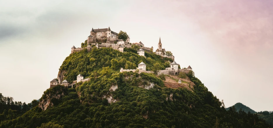 a castle sitting on top of a lush green hillside, by Matthias Weischer, pexels contest winner, herzog de meuron, brown, whitewashed buildings, castelvania