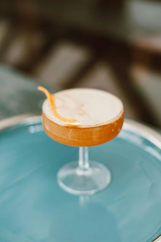 a cocktail sitting on top of a blue plate, caramel, thumbnail, dapper, detail shot