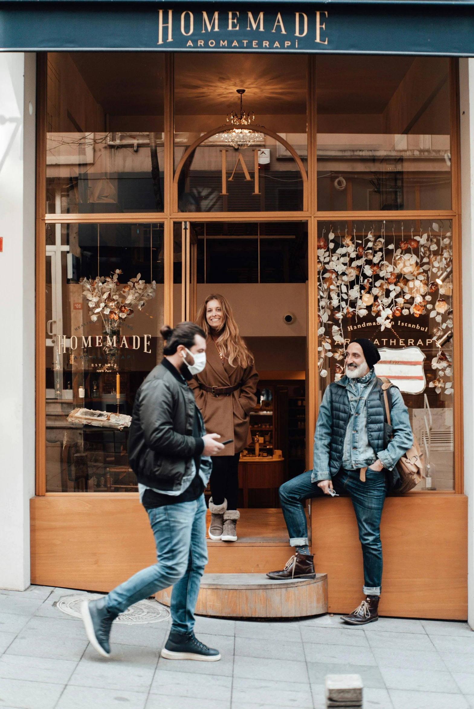 a couple of people that are standing in front of a store, brown clothes, in paris, coworkers, freddy mamani silvestre facade