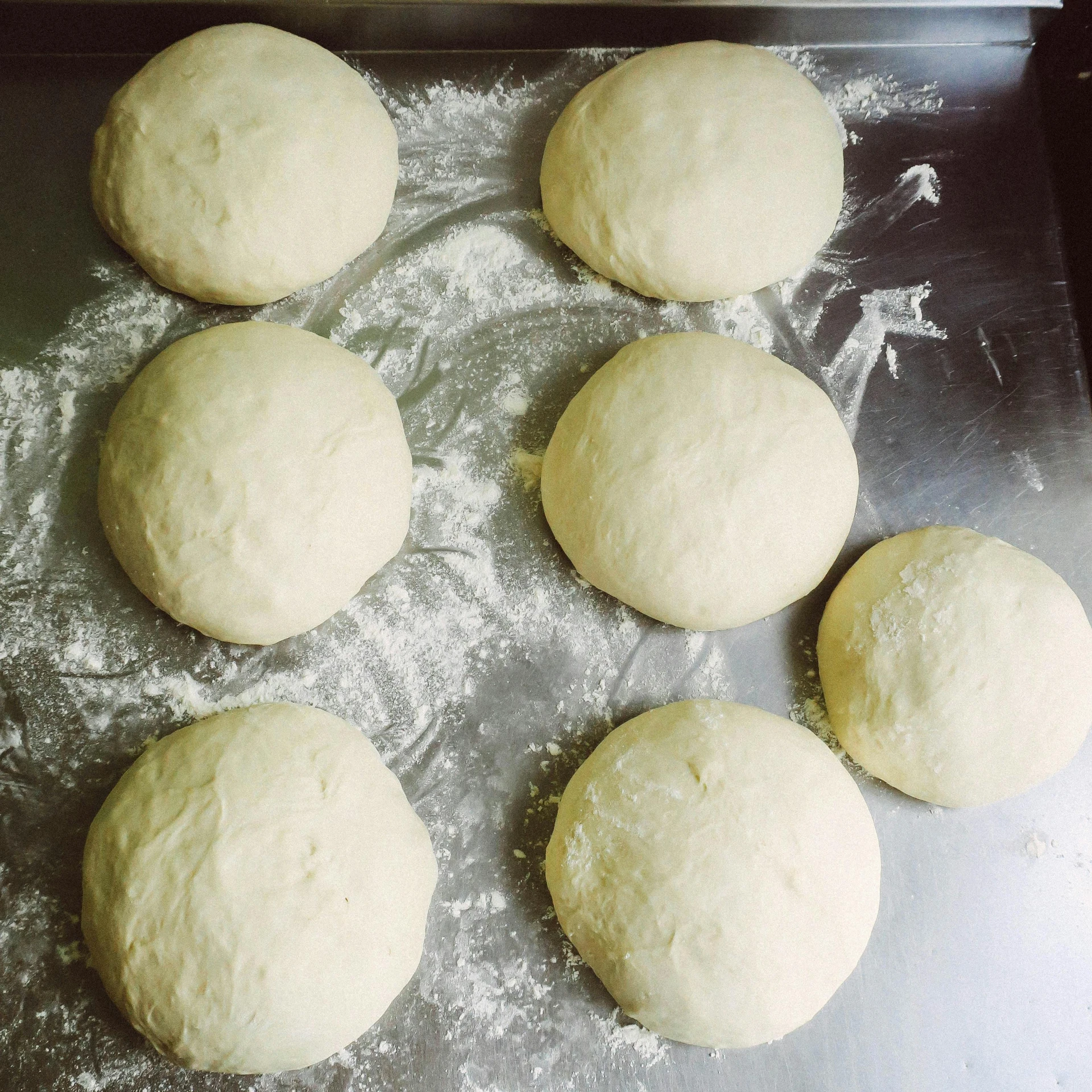 a pan filled with dough sitting on top of a table, 6 pack, very round, full head and shoulders, pastel'