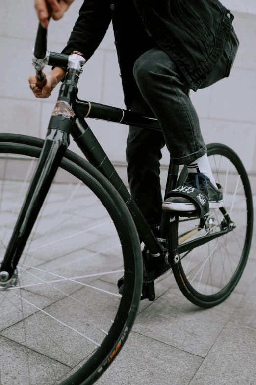 a man riding a bike down a sidewalk, pexels contest winner, black main color, mechanical details, zoomed out view, sustainable materials