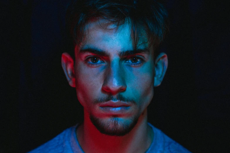 a man standing in front of a black background, a character portrait, pexels contest winner, bisexual lighting, blue symmetric eyes 24yo, diego fernandez, discord profile picture