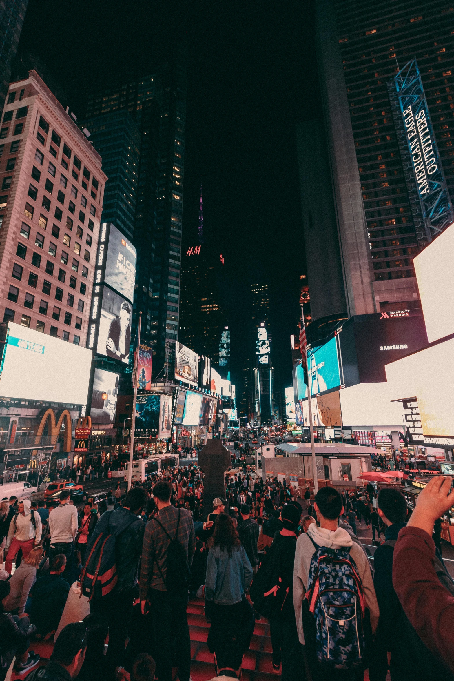 a crowd of people walking through a city at night, pexels contest winner, happening, in time square, panoramic shot, square, billboard image