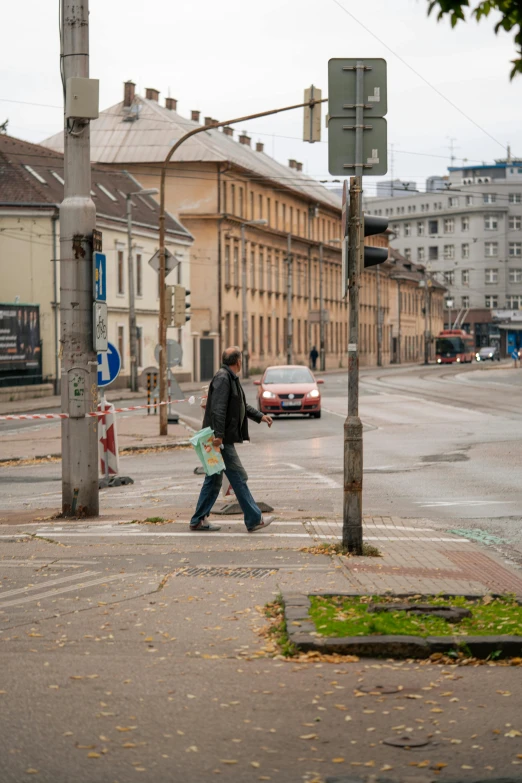 a couple of people walking across a street, viennese actionism, abandoned streets, intersection, empty streetscapes, brown