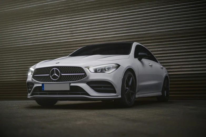 a white mercedes cla parked in front of a garage door, pexels contest winner, 4 k cinematic still, front, plain background, aftermarket parts