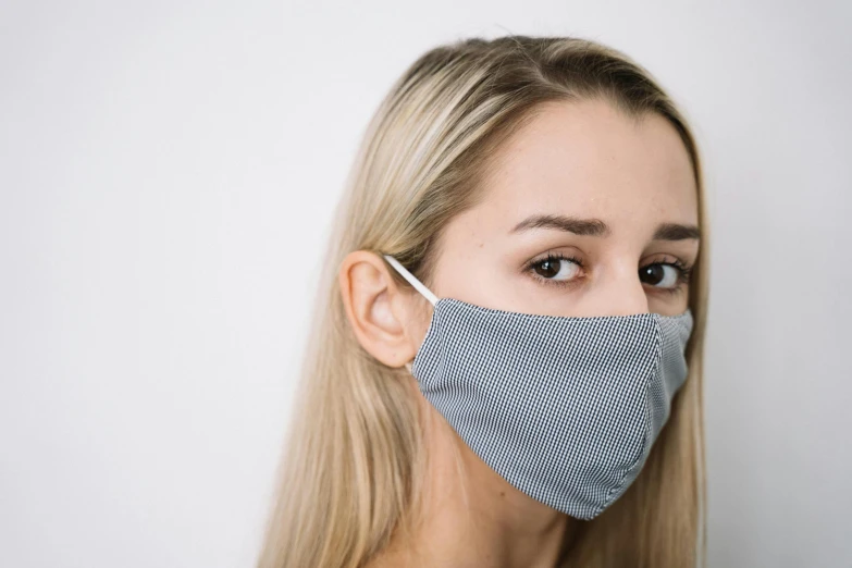 a woman wearing a blue and white face mask, a stipple, pexels, antipodeans, dressed in a gray, handsome girl, product shot, a girl with blonde hair