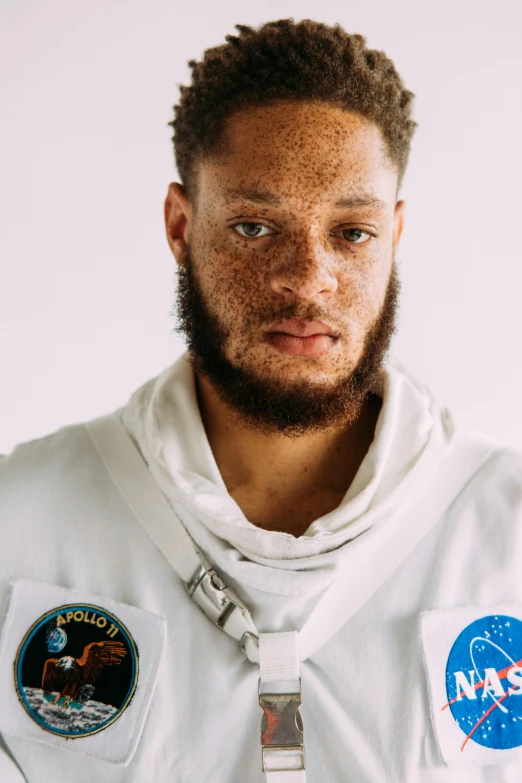 a man in an astronaut suit posing for a picture, inspired by Jules Tavernier, pete davidson, head and shoulders shot, david uzochukwu, official photo