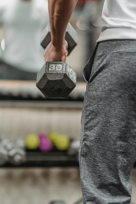 a close up of a person holding a pair of dumbbells, curated collections, grey, bum, geo