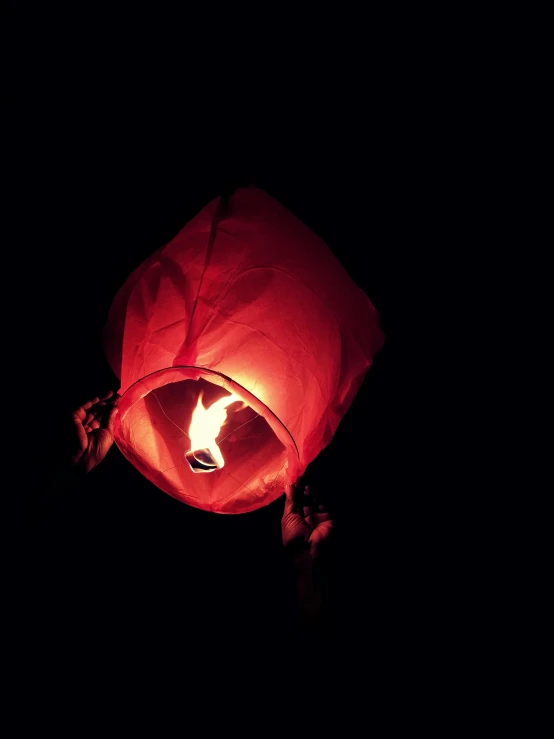 a person holding a lit up lantern in the dark, an album cover, pexels contest winner, hurufiyya, balloon, mangeta smoke red light, square, taken in the late 2010s