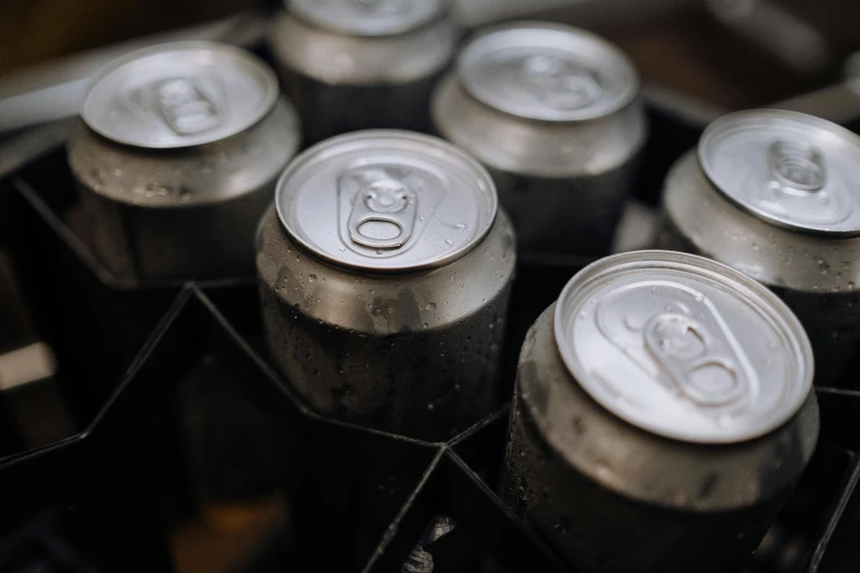 a bunch of soda cans stacked on top of each other, pexels contest winner, morning hard light, grey metal body, beer logo, eight eight eight