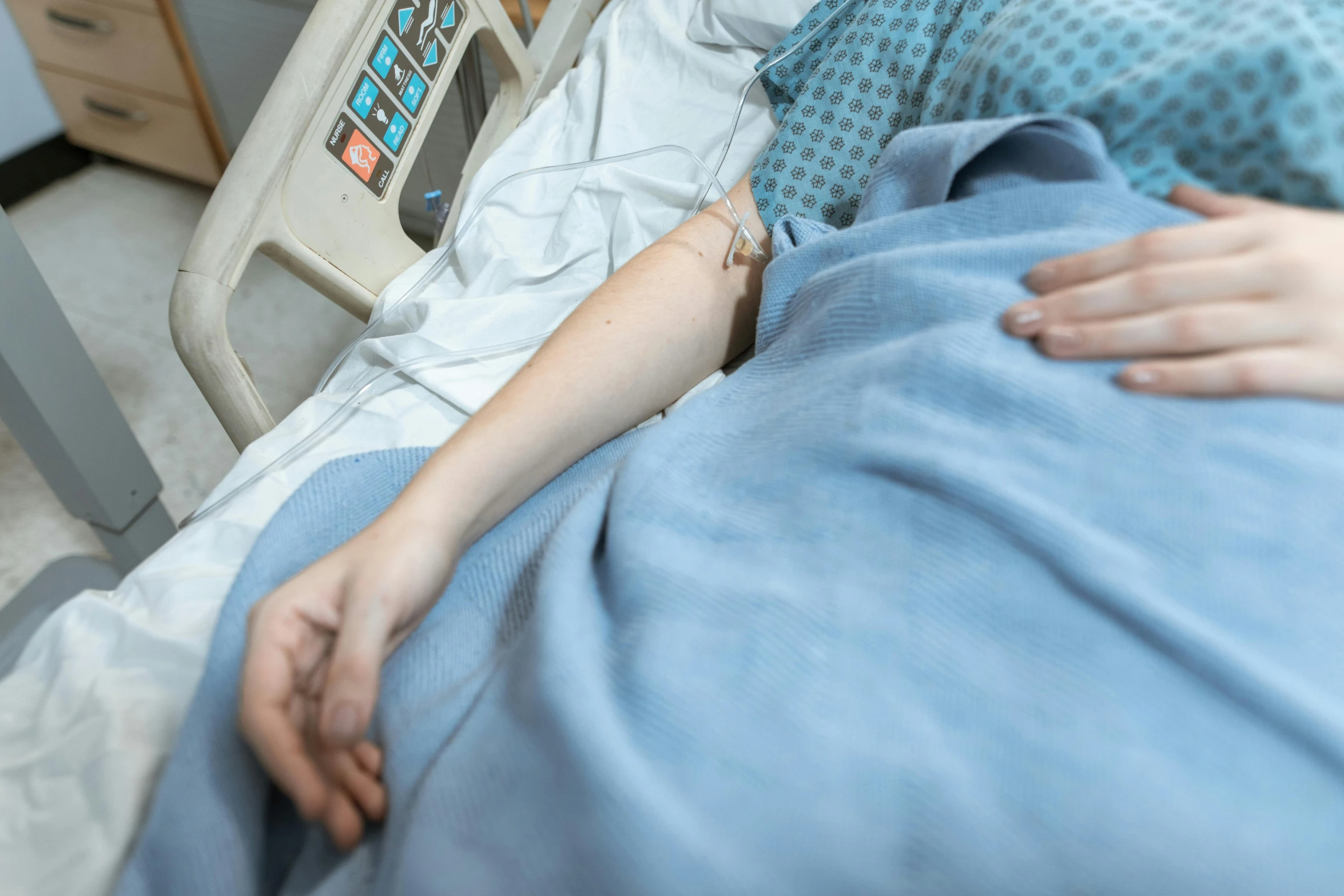 a woman is laying in a hospital bed, by Meredith Dillman, pexels, bump in form of hand, lachlan bailey, thumbnail, coloured