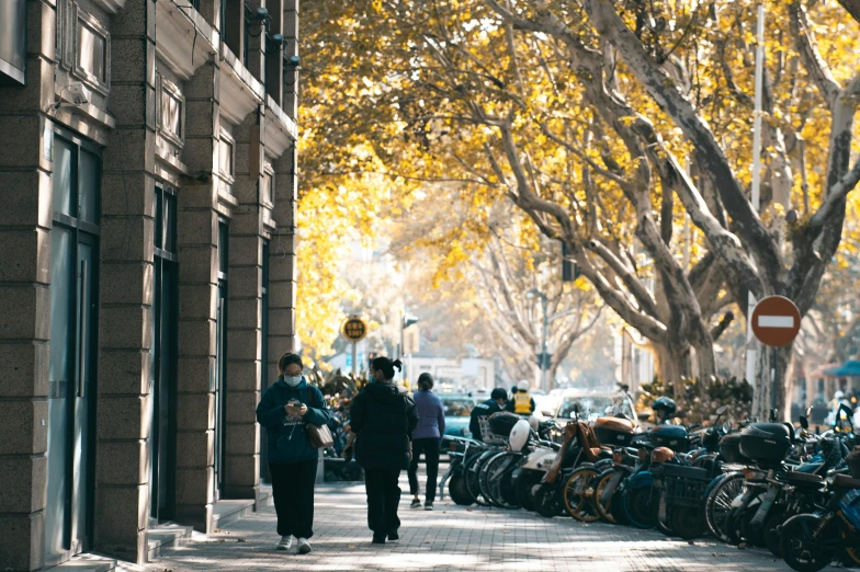 a man walking down a sidewalk next to a row of parked motorcycles, pexels contest winner, happening, autumnal, in chippendale sydney, avatar image, in barcelona