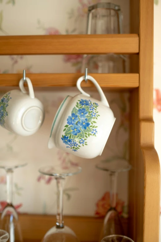 a close up of a shelf with cups and glasses, inspired by Annabel Kidston, happening, blue flowers accents, laundry hanging, hero shot, square