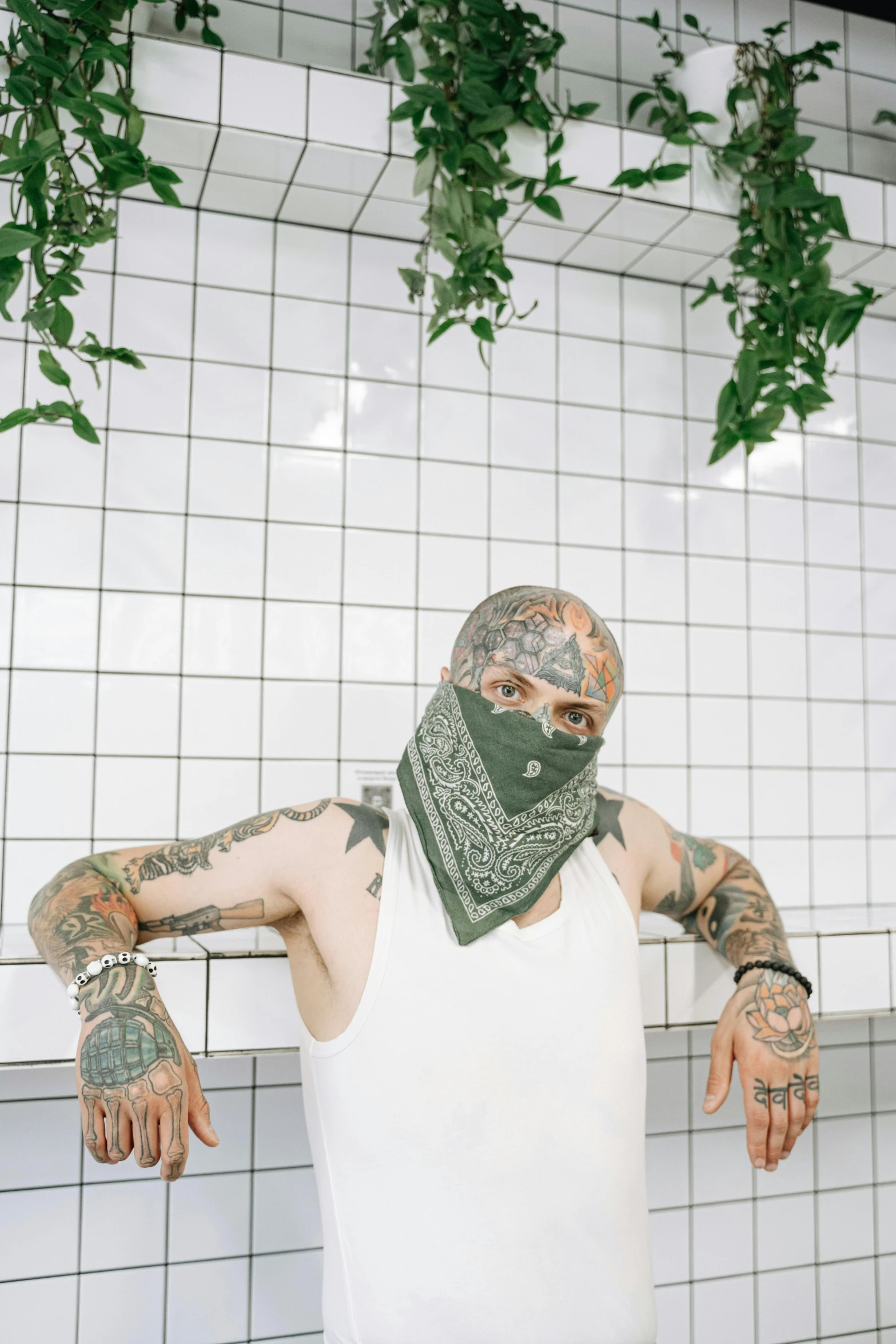 a man wearing a bandana standing in front of a tiled wall, a tattoo, inspired by Elsa Bleda, in a laundry mat, green head, in front of white back drop, 2019 trending photo