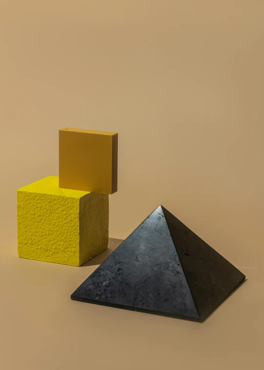 a couple of pyramids sitting next to each other, an abstract sculpture, by Harvey Quaytman, trending on unsplash, yellow charcoal, ignant, detailed product image, color blocks