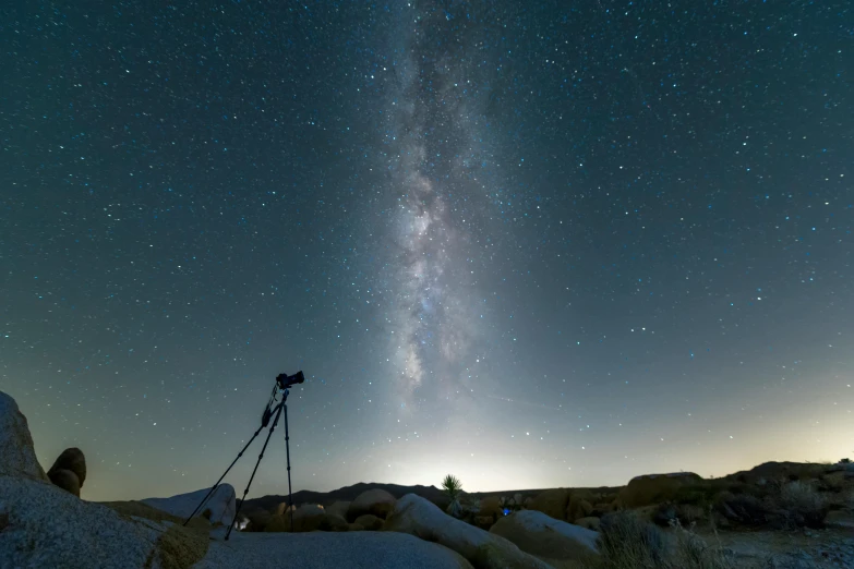 a telescope sitting on top of a rock under a night sky, mojave desert, a still of an ethereal, lpoty, camera looking up