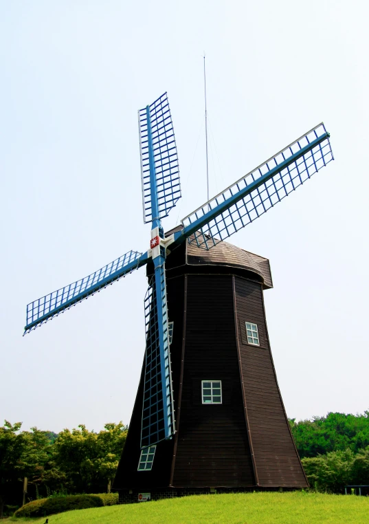 a windmill sitting on top of a lush green field, mingei, avatar image, square, sangyeob park, no - text no - logo