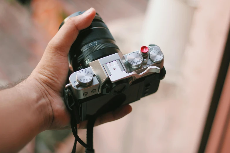 a close up of a person holding a camera, a picture, xf iq4, flatlay, instagram post, fujifilm x-t3