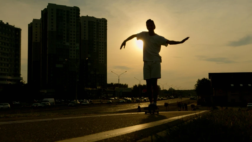 a man riding a skateboard down the side of a road, by Attila Meszlenyi, pexels contest winner, realism, in moscow centre, backlight body, 15081959 21121991 01012000 4k, summer evening