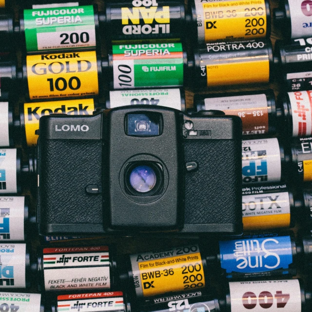 a camera sitting on top of a pile of batteries, a picture, unsplash, color film expired film, medium format, used tape, lomography