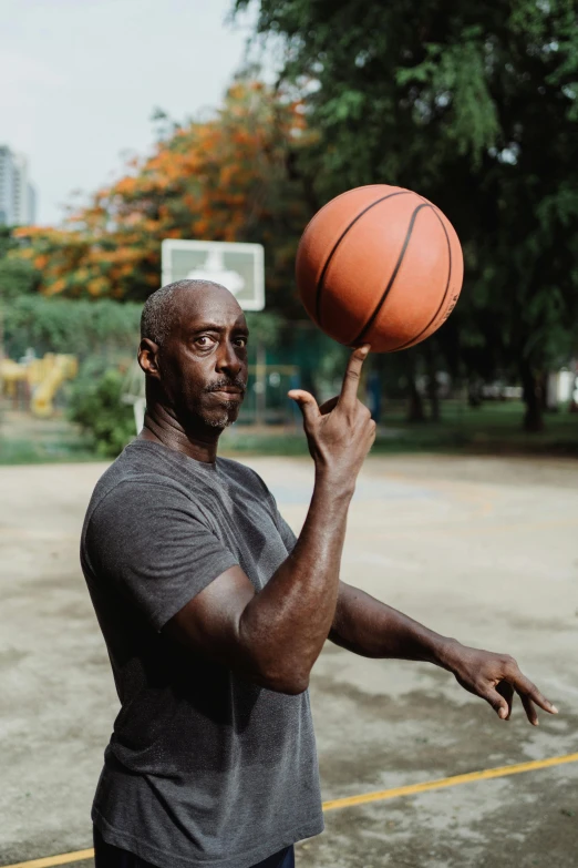 a man spinning a basketball on his finger, pexels contest winner, lance reddick, confident pose, portrait of a big, 15081959 21121991 01012000 4k