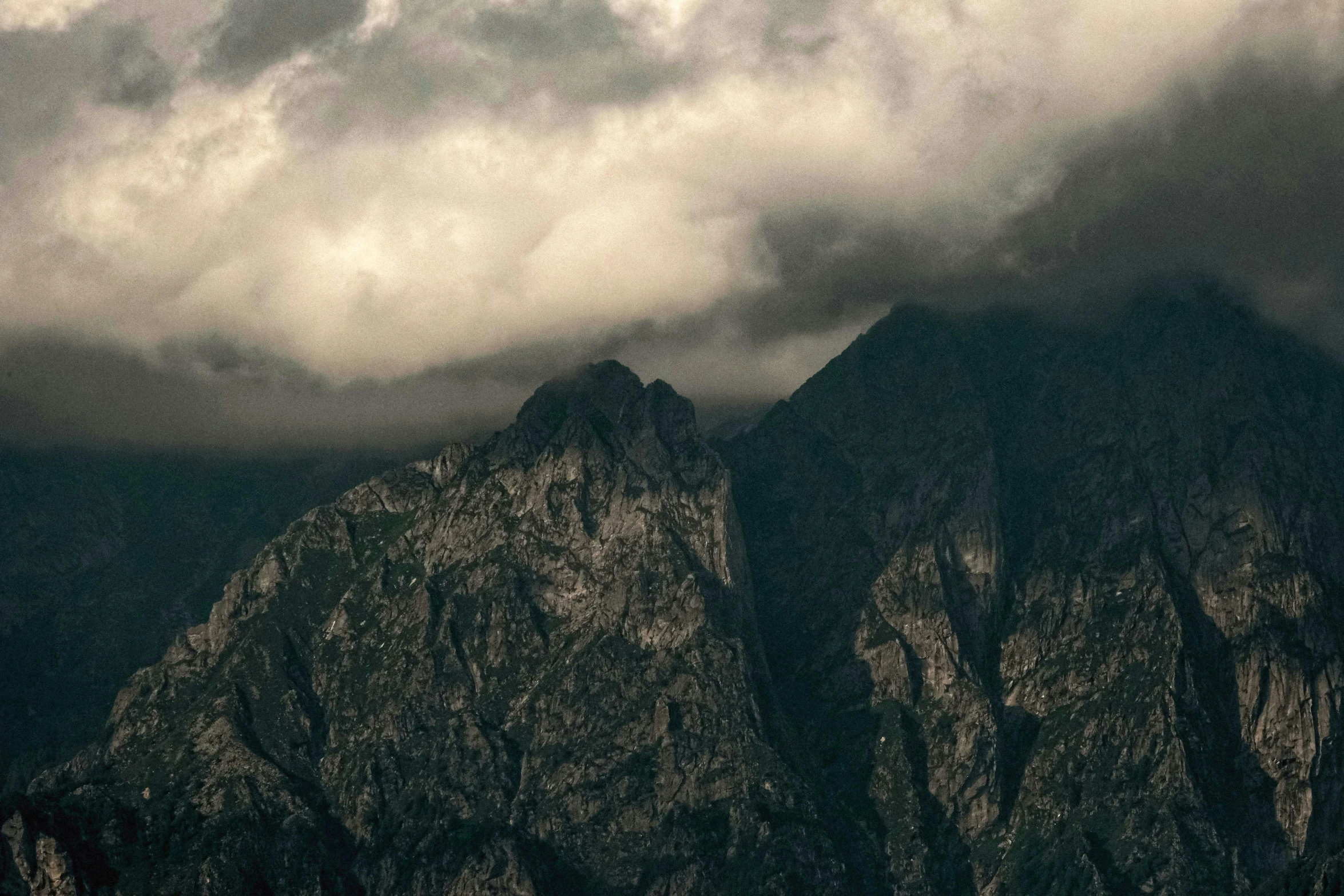 a plane flying over a mountain range under a cloudy sky, by Adam Marczyński, pexels contest winner, romanticism, old photo of a creepy landscape, dark rocks, mount olympus, timelapse