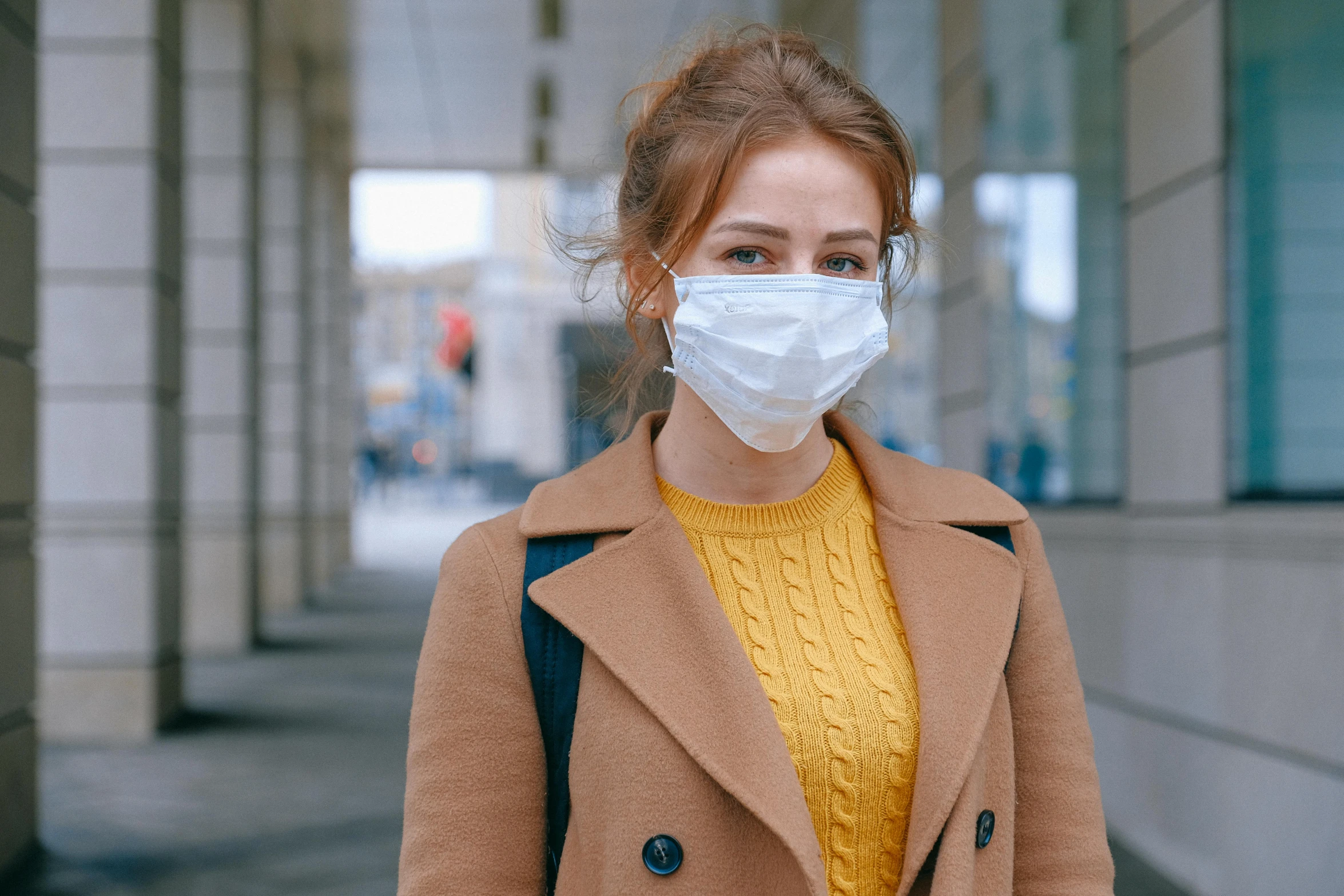 a woman wearing a face mask on a city street, trending on pexels, brown, worksafe. instagram photo, smug appearance, medicine