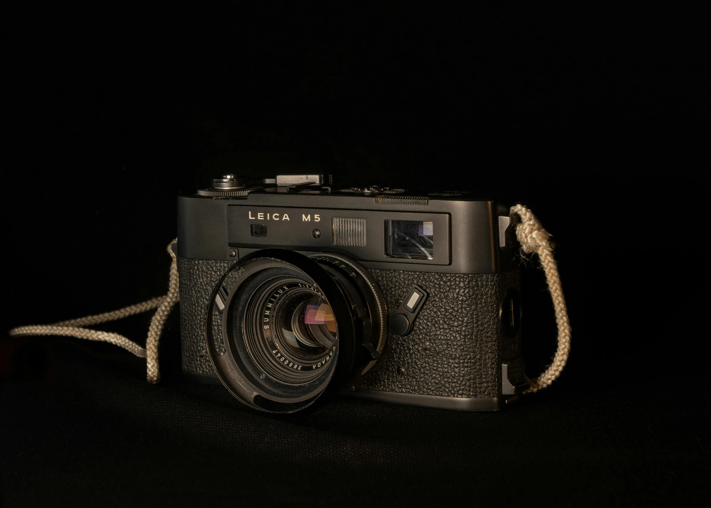 a close up of a camera on a black background, by Niels Lergaard, art photography, photo 3 5 mm leica, impeccable military composure, ecommerce photograph, full body in camera