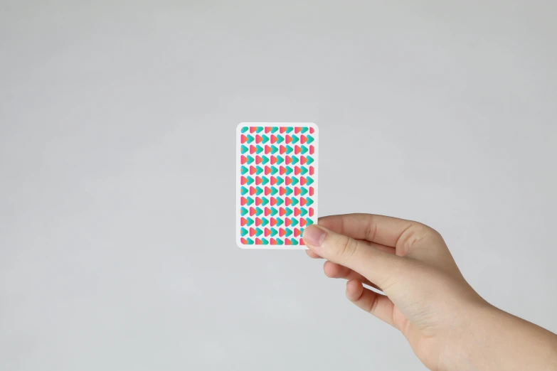 a person holding a playing card in their hand, inspired by Okada Hanko, optical illusion, turquoise pink and green, gumdrops, card back template, gumroad