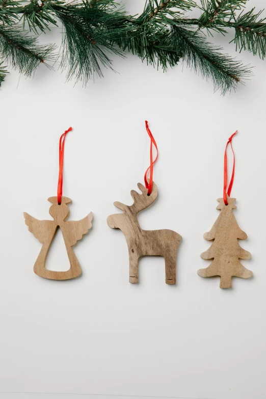 three wooden ornaments hanging from a christmas tree, by Alison Debenham, 3 - piece, ox