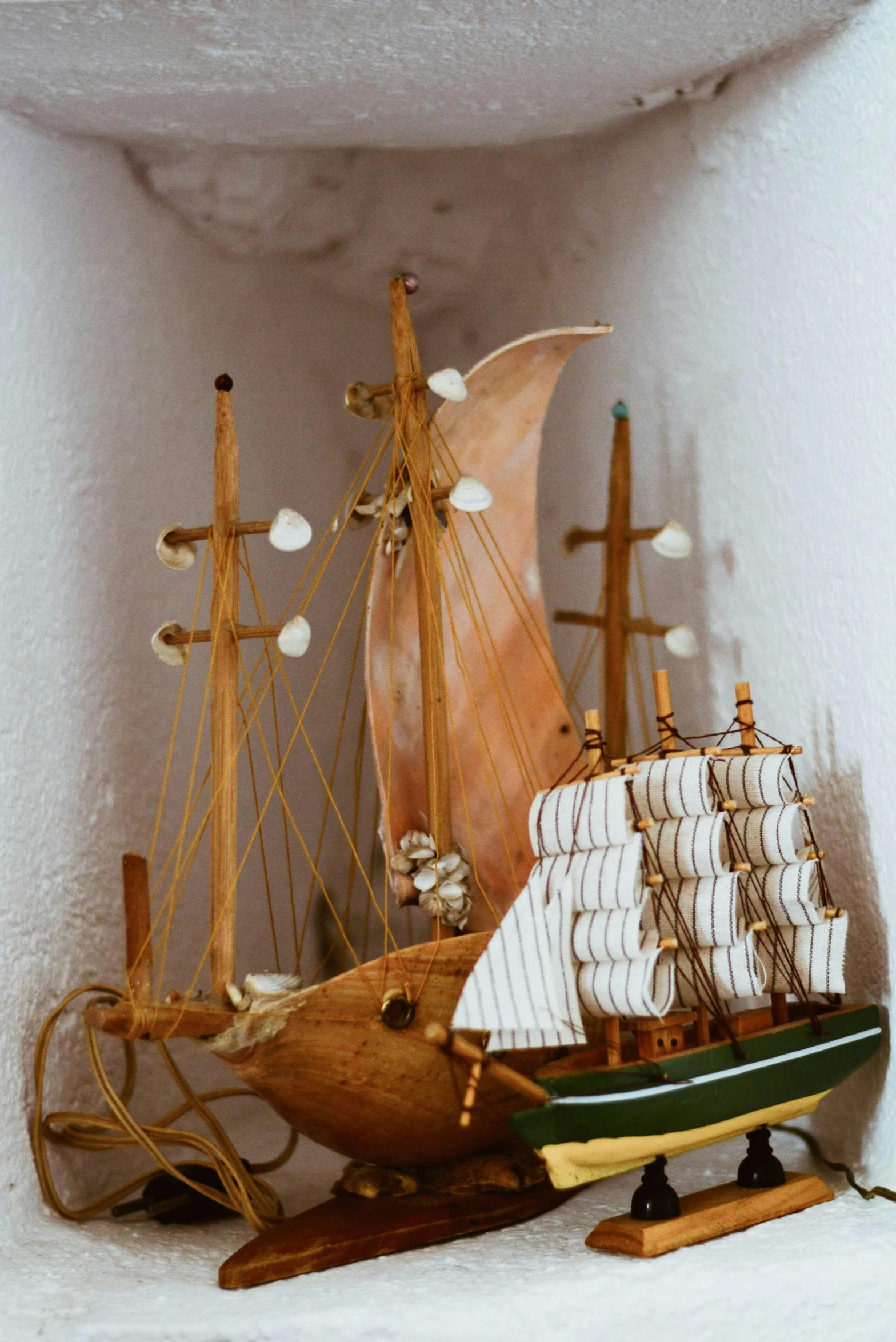 a couple of boats sitting on top of a shelf, inspired by Charles Gleyre, unsplash, folk art, full frame image, cornucopia, close - up photo, ship interior